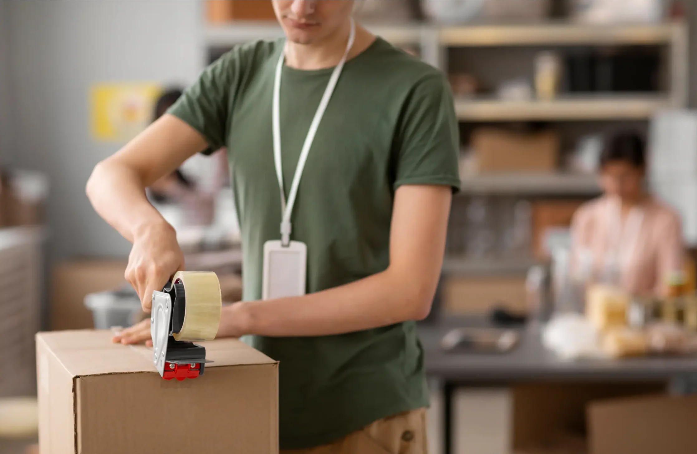 guy closing a box with tape
